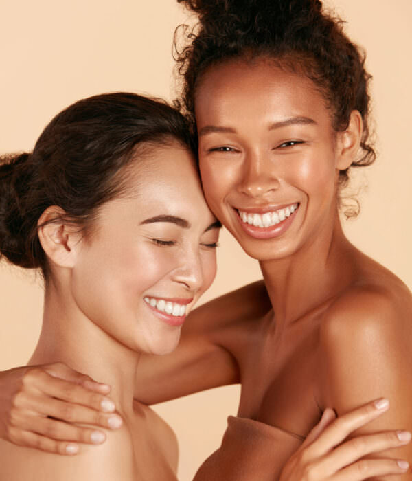 Beauty. Smiling women with perfect face skin and makeup portrait Beauty. Smiling women with perfect face skin and natural makeup portrait. Beautiful happy asian and african girl models with different types of skin on beige background. Spa skin care concept